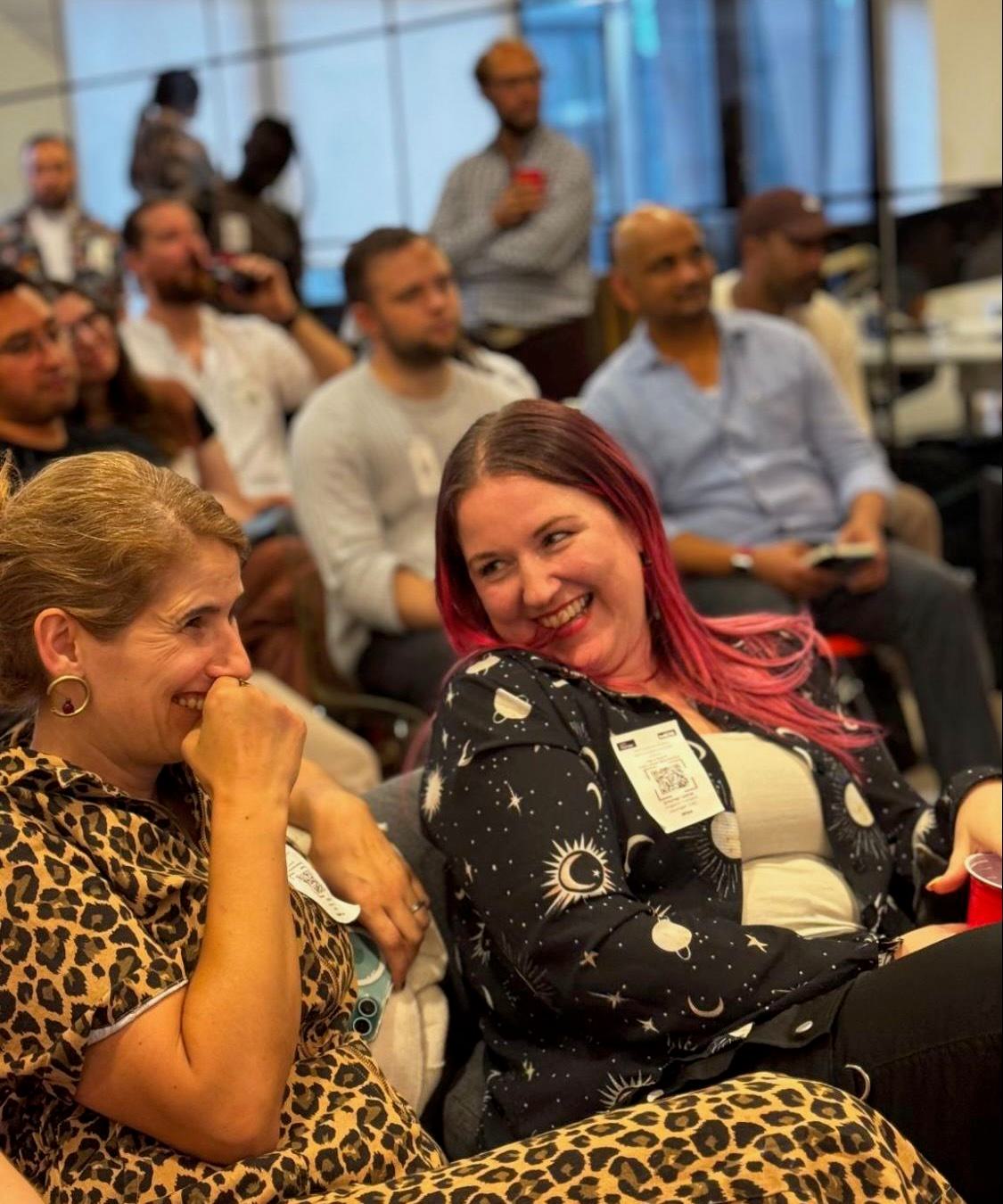 Guests laughing together at Sip & Search SEO Meetup