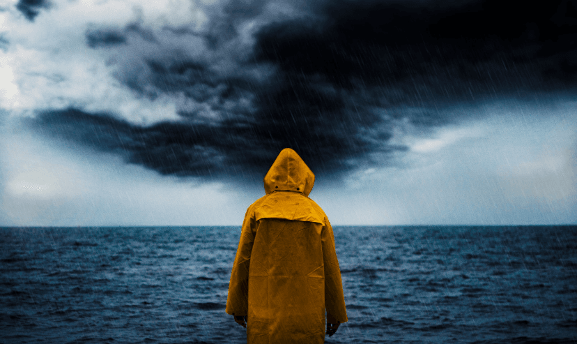 Person in yellow coat in stormy weather